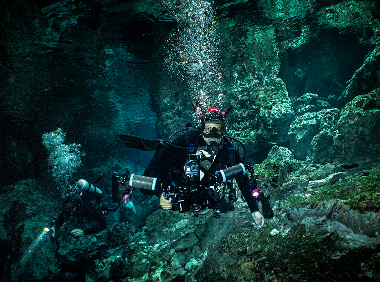 Scuba divers in cenotes Tajma Ha in Mexico