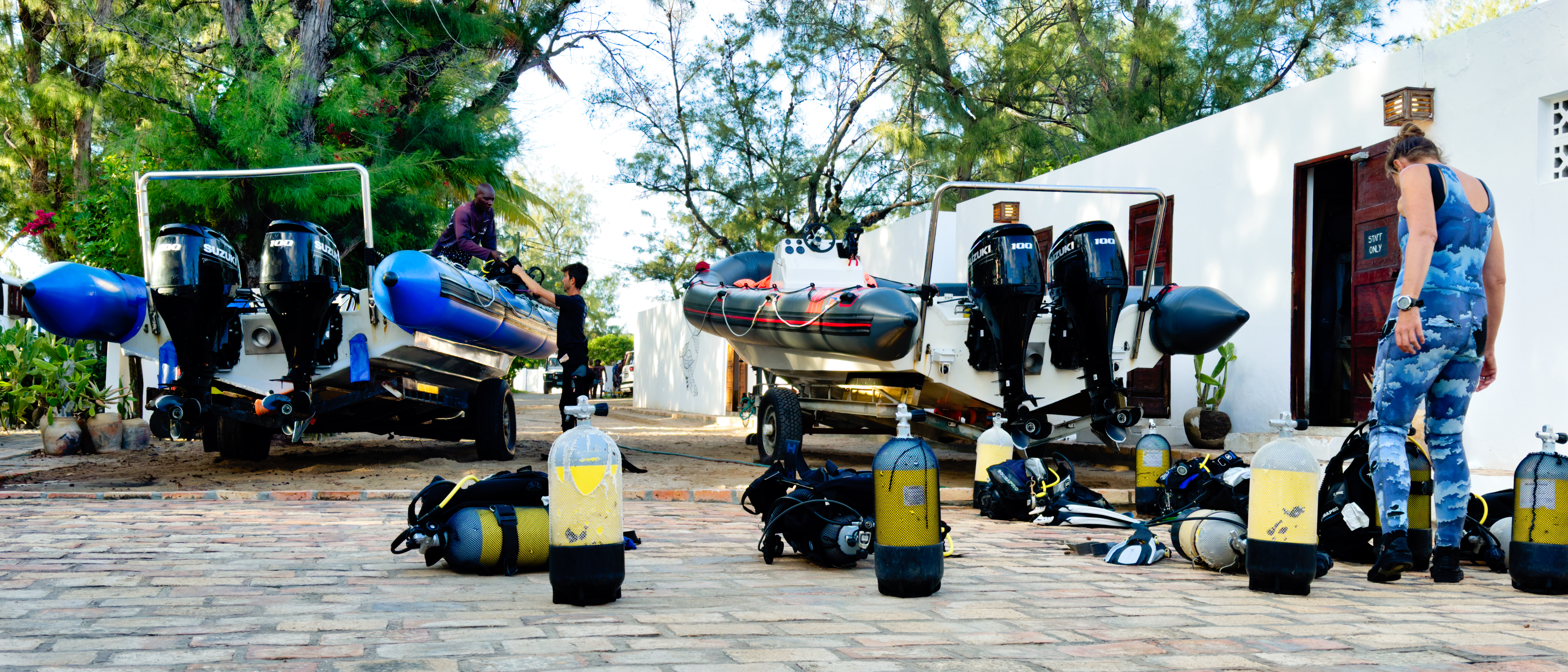 Scuba gear laid out on a dock—BCD, regulator, fins, and mask before a dive.