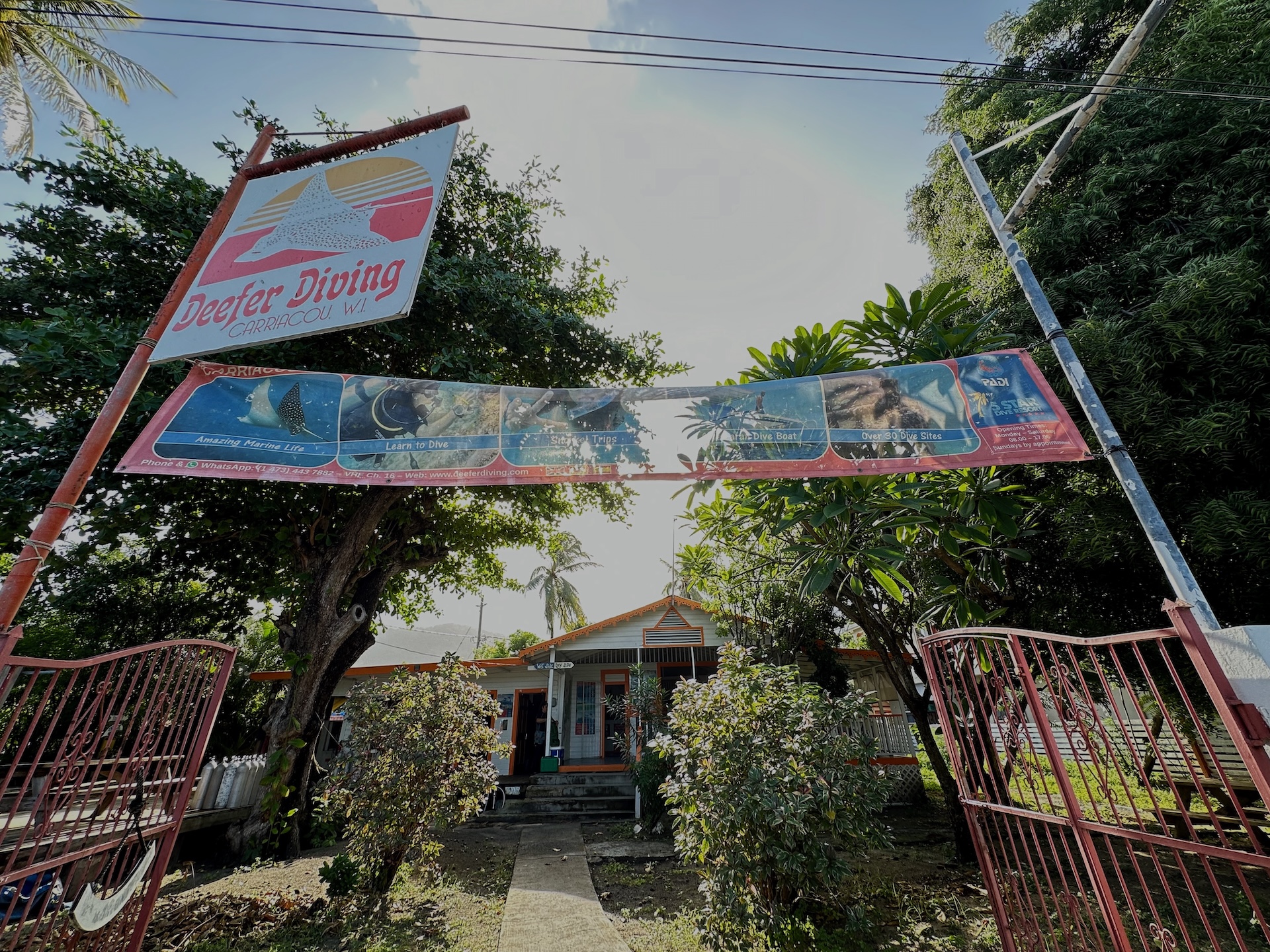 Entrance to Deefer Diving dive shop in Carriacou, Grenada, with PADI 5 Star Dive Center signage