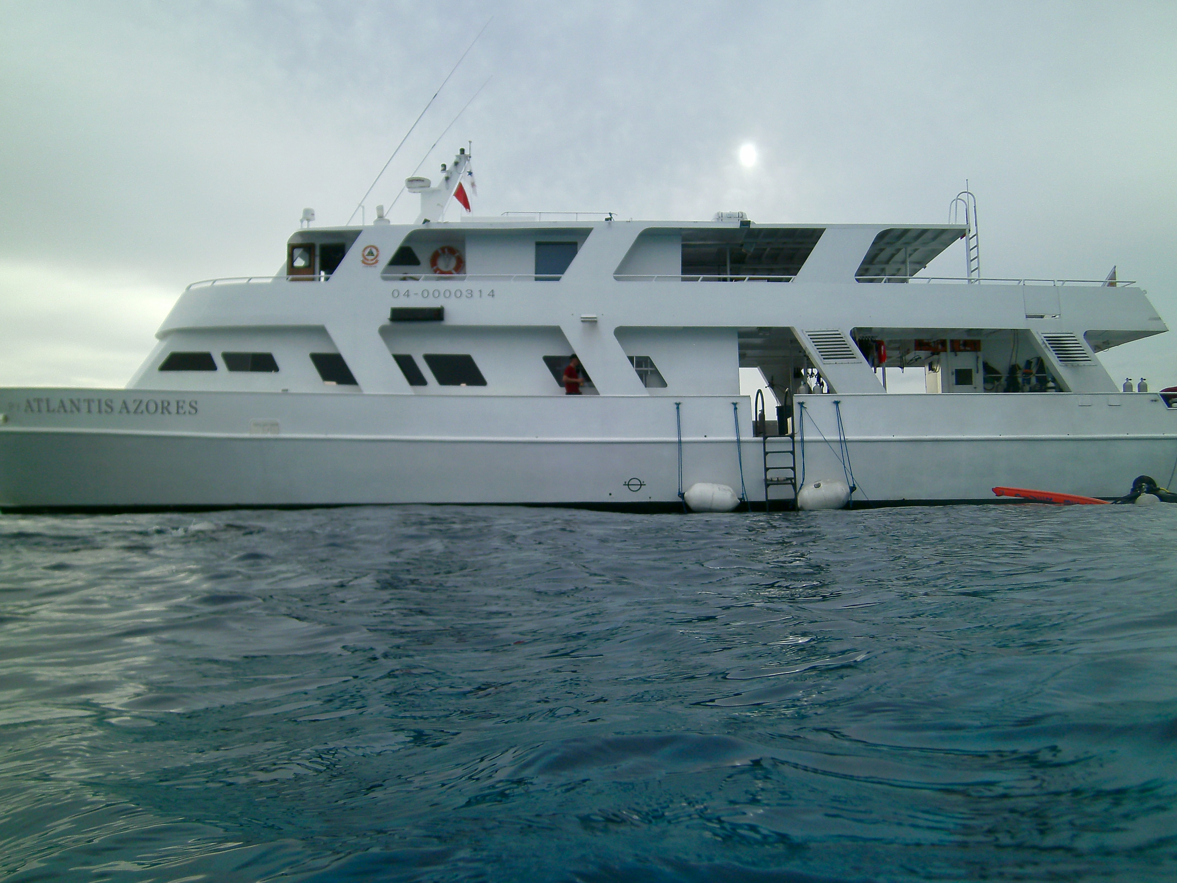 Atlantis Azores liveaboard vessel anchored in the Philippine Visayas, viewed from water level.